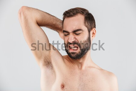 Young man spraying water on his face Stock photo © deandrobot