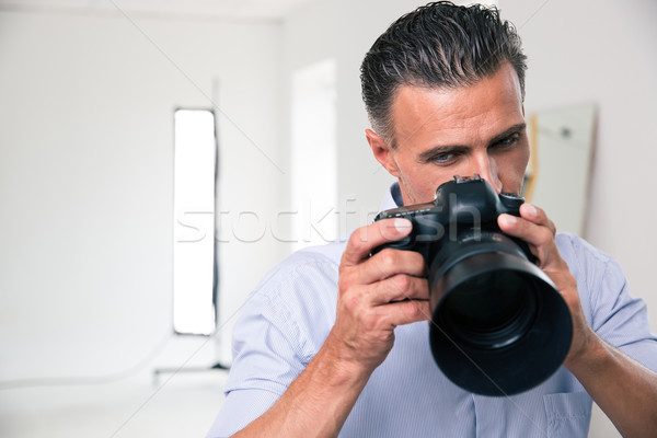 Photographer using camera Stock photo © deandrobot