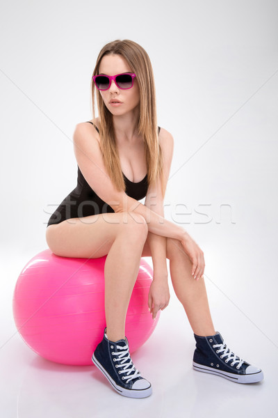 Modern style dancer posing on pink fitball Stock photo © deandrobot
