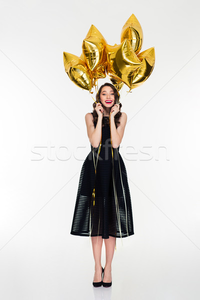 Excited cheerful woman with bright golden balloons celebrate her birthday Stock photo © deandrobot