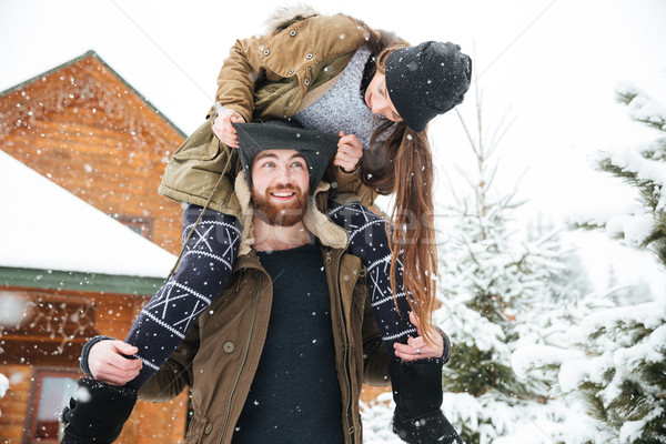 Woman sitting on man shoulders and having fun in winter Stock photo © deandrobot