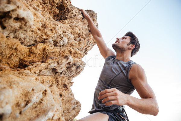 Hombre rock empinado acantilado pared Foto stock © deandrobot