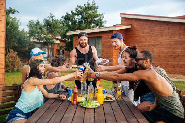 Happy young people celebrating and having outdoor party Stock photo © deandrobot