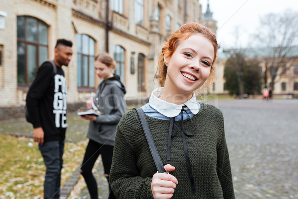 счастливым женщину студент рюкзак Постоянный за пределами Сток-фото © deandrobot