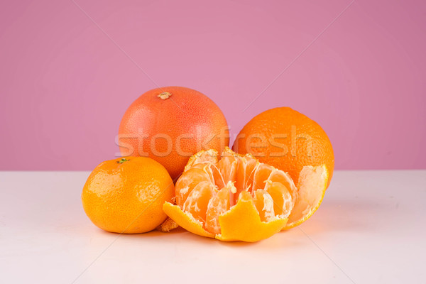 Fresh fruit mandarin, persimmon tangerine and orange on a table Stock photo © deandrobot
