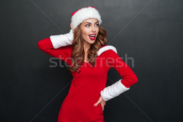 Beautiful woman in santa's costume looking away Stock photo © deandrobot