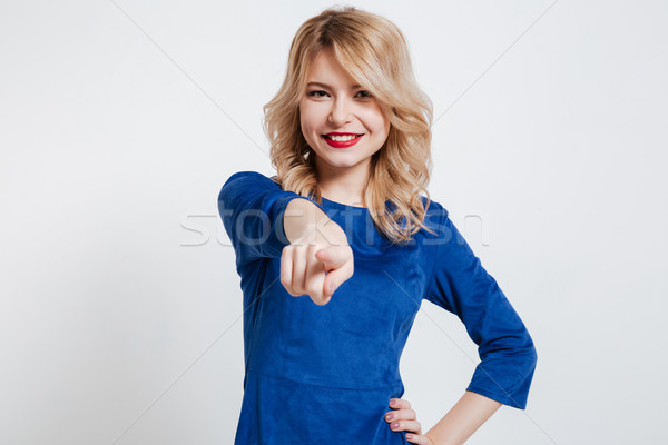 Lady pointing to camera. Stock photo © deandrobot