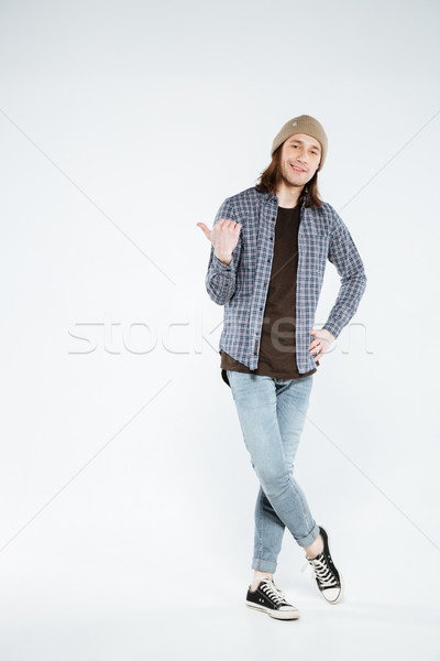 Vertical image of hipster pointing away Stock photo © deandrobot