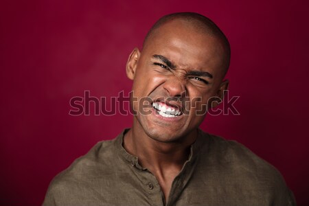 Close up portrait of angry african man looking at camera Stock photo © deandrobot