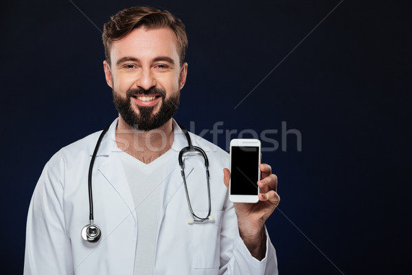 Portré boldog férfi orvos egyenruha sztetoszkóp mutat Stock fotó © deandrobot