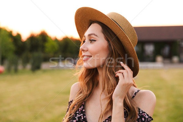 Portrait of amazing young woman 20s wearing straw hat smiling, a Stock photo © deandrobot