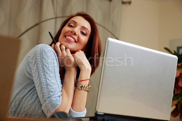 Portrait of a happy woman sitting on her workout at home Stock photo © deandrobot