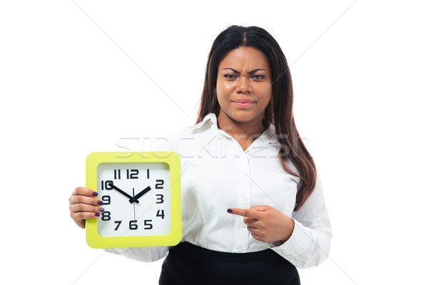 Dissatisfied businesswoman pointing finger on the clock Stock photo © deandrobot