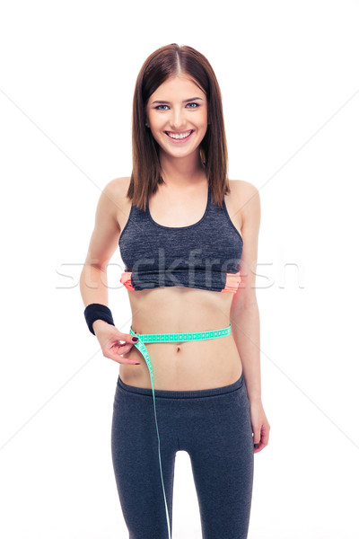 Woman measuring her tummy with a measuring tape Stock photo © deandrobot
