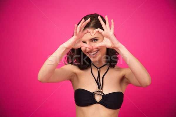 Woman making heart shape with hands  Stock photo © deandrobot