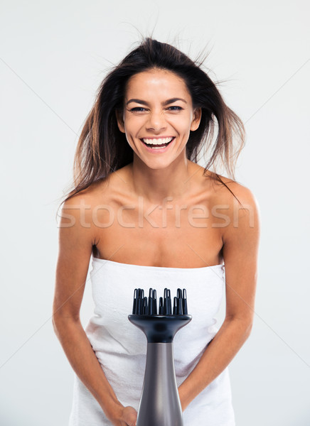 Laughing woman in towel drying her hair  Stock photo © deandrobot