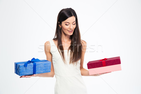Woman making choice between two gift boxes Stock photo © deandrobot