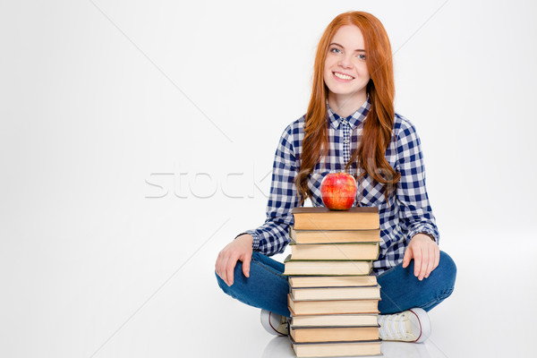 Kobieta posiedzenia książek jabłko górę Zdjęcia stock © deandrobot