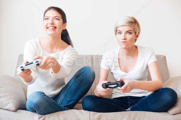 Girlfriends playing video games Stock photo © deandrobot