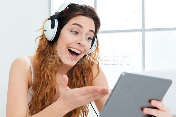 Cheerful woman video chatting on tablet computer Stock photo © deandrobot