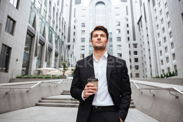 Businessman drinking take away coffee in the city Stock photo © deandrobot