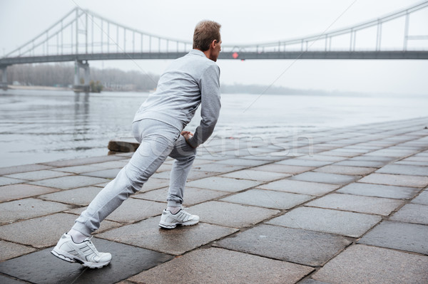 Full length runner warming up near the water Stock photo © deandrobot