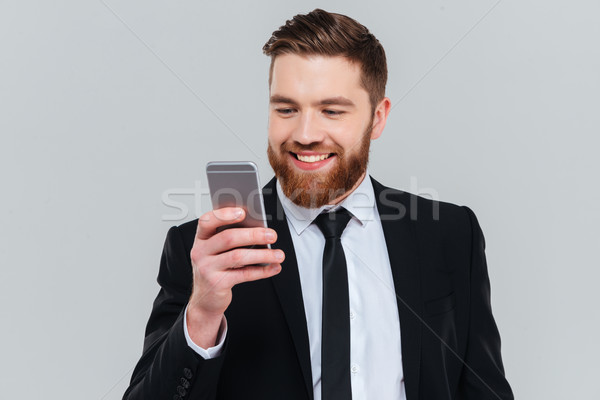 Business man writing message on phone Stock photo © deandrobot