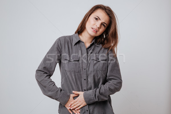 Ziek jonge vrouw aanraken buik foto shirt Stockfoto © deandrobot