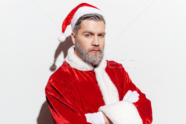 Portrait of man santa claus standing with arms crossed Stock photo © deandrobot