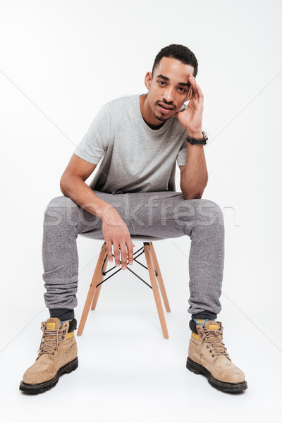 Handsome young dark skinned man Stock photo © deandrobot