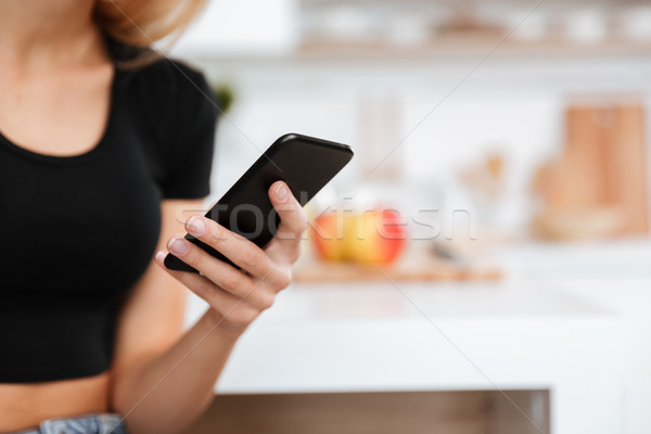 Cropped image of woman writing message Stock photo © deandrobot