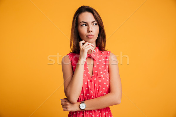 Portrait of thoughtful beautiful brunette woman, touching her ch Stock photo © deandrobot
