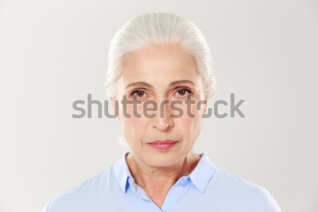 Close-up portrait of beautiful old woman in blue shirt, looking  Stock photo © deandrobot