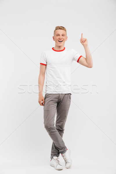 Full length portrait of a smiling teenage boy Stock photo © deandrobot