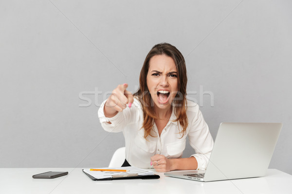 Stock photo: Portrait of a mad young business woman