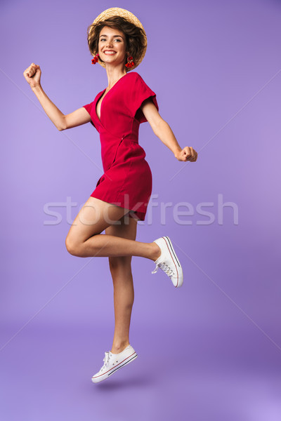 Full length portrait of a cheerful young woman in hat Stock photo © deandrobot