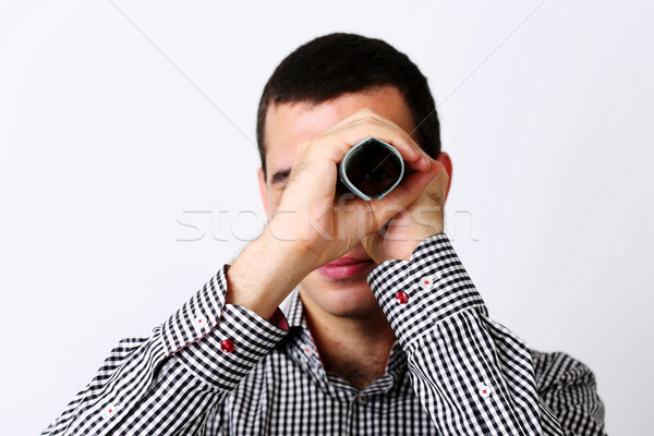 Businessman looks at camera through tube from dollars Stock photo © deandrobot