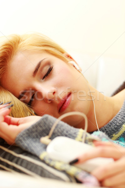 Young sleeping woman listening music Stock photo © deandrobot