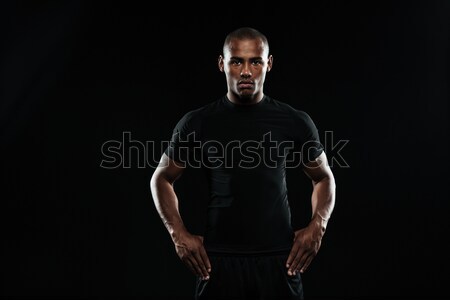 Stock photo: Naked sportsman standing with his hands wrapped with elastic bandage on gray background