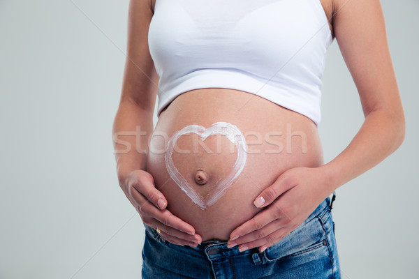 Pregnant woman with heart shape Stock photo © deandrobot