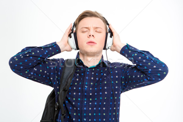 Stock photo: Young male listening to music with eyes closed