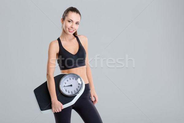 Piękna uśmiechnięty młodych kobieta fitness dres Zdjęcia stock © deandrobot