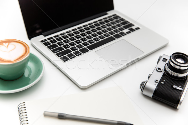 Laptop, vintage camera, cup of coffee, notepad and pen  Stock photo © deandrobot