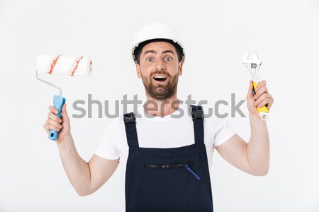 Bearded man holding bottle of beer and showing thumbs up Stock photo © deandrobot