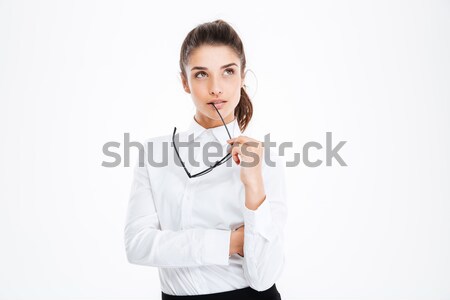 Thoughtful young business woman holding glasses and thinking Stock photo © deandrobot