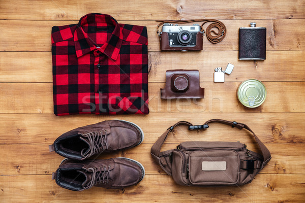 Travel concept boots, shirt, camera, lighter, flask, bag Stock photo © deandrobot