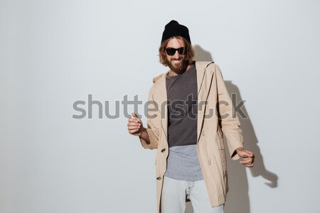 Portrait of a man in hat taking off his eyeglasses Stock photo © deandrobot