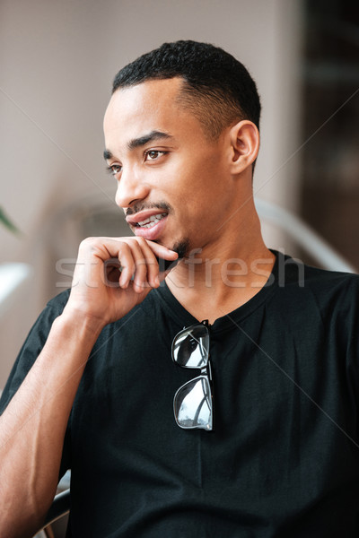 Portrait of a thoughtful young afro american man indoors Stock photo © deandrobot