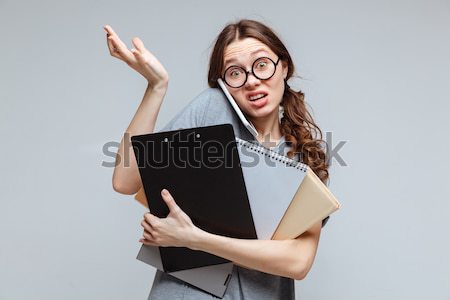 Female nerd talking on phone and does not understand Stock photo © deandrobot