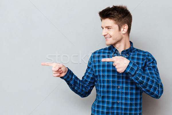 Stock photo: Young man showing at empty space